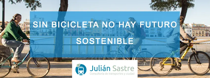 Persona en bicicleta circulando por un carril bici urbano rodeado de árboles, representando la movilidad sostenible en las ciudades